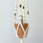 Small terracotta pot hanging from rope macrame