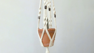 Small terracotta pot hanging from rope macrame